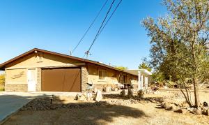 a house with a garage in front of it at Desert Ruby in Yucca Valley
