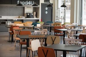 a restaurant with tables and chairs in a cafeteria at Hotel Bed4U Santander in Santander