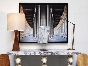 a table with a lamp and a picture of a organ at J.K. Place Roma - The Leading Hotels of the World in Rome