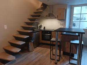 a kitchen with a spiral staircase in a room at Studio Centre Ville Chinon in Chinon