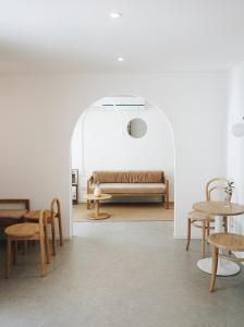 a room with a bed and tables and chairs at Evergreen Cafe and Hotel in Chiang Mai