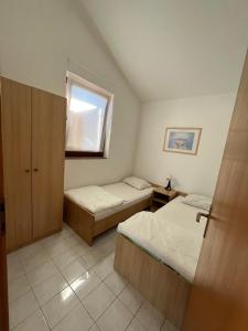 מיטה או מיטות בחדר ב-Apartmani Hranjec