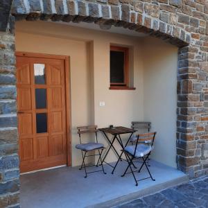 a patio with a table and two chairs and a door at Apartma Rok in Plavje