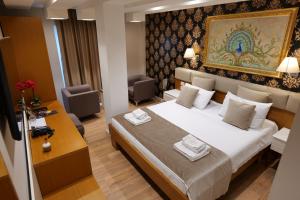 a hotel room with a bed with towels on it at Hotel Queen in Tirana +41 photos