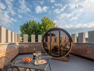 a patio with a table and a round mirror at VILLA BERNASCONI in Narzole