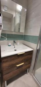 a bathroom with a sink and a mirror at Dream French Riviera - FAME Marina Baie des Anges in Villeneuve-Loubet
