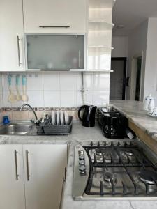 a kitchen with a stove top and a sink at Residence Mariem in Ariana