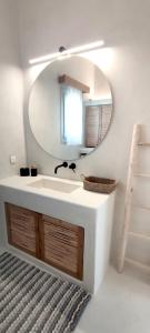 a bathroom with a sink and a mirror at Degaetas Resort in Antiparos
