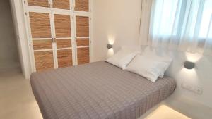 a small bedroom with a bed with two pillows at Degaetas Resort in Antiparos
