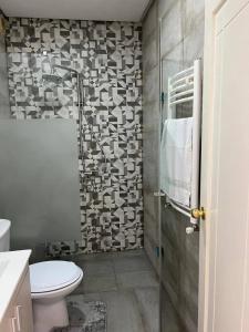 a bathroom with a toilet and a glass shower at Residence Mariem in Ariana