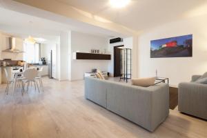 a living room with a couch and a table at Urban Homy Gorizia in Gorizia
