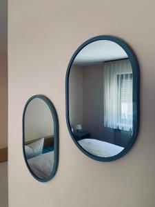 a mirror on a wall next to a bedroom at Forsterhof in Pottenstein