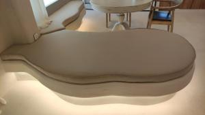 a white couch sitting in a room with a table at Degaetas Resort in Antiparos