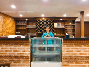 a man behind the counter of a bar at Kathmandu Aagantuk Hotel in Kathmandu