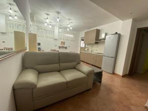 ein Wohnzimmer mit einem Sofa und einer Küche in der Unterkunft Santa Marina Inn in Milazzo