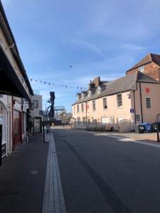 an empty street in a town with buildings at Quayside in Poole