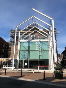 a building with a large glass facade on a street at Quayside in Poole