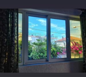 a window with a view of a garden at Vila Ester in Ksamil