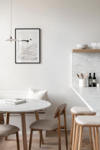 a dining room with a white table and chairs at The Paragon, Bath in Bath