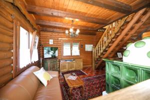 a living room with a couch in a log cabin at Blockhaus Edelsberg in Sebersdorf