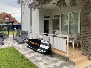 a surfboard sitting on a porch of a house at Révai Apartman Fonyód in Fonyód