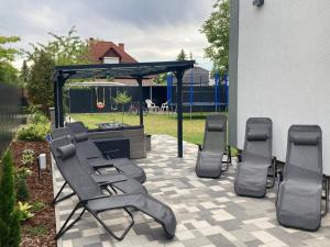 a patio with a group of chairs and a gazebo at Révai Apartman Fonyód in Fonyód