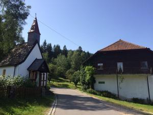 a house and a church and a road at Ferienwohnung Gut Eschlsaign in Arrach