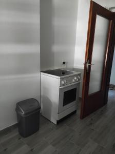 a kitchen with a stove and a trash can at Fortuna in Vrdnik