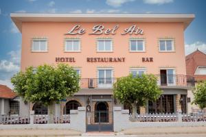 a large pink building with the words la bed inn at Le Bel Air in Mions