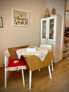 a dining room table with two chairs and a table with a laptop at Casa GaEl in Fiumalbo