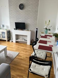 a living room with a table and a fireplace at Lovely 2-bedroom apartment in Zone 2 London in London