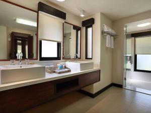 a large bathroom with two sinks and a shower at Novotel Lombok Resort & Villas in Kuta Lombok