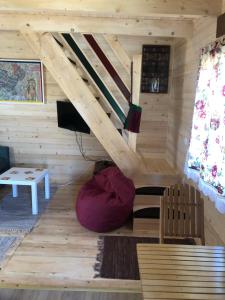 a room in a log cabin with a tv at Tilia Cottage Banjska stena in Mitrovac