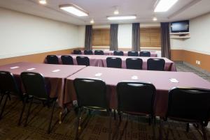 a conference room with a long table and chairs at AmericInn by Wyndham Osceola in Osceola +28 photos
