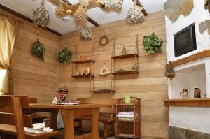 a dining room with a wooden wall with a table at Slavyanskiy Club in Poltava