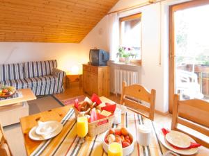 a living room with a table with food on it at Landhaus am Breitenberg in Pfronten