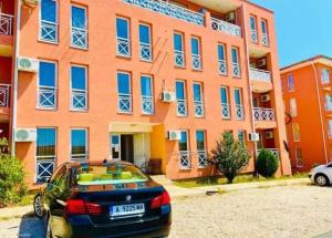 a car parked in front of a building at Sunny Day 6 in Sunny Beach