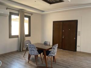 a dining room with a wooden table and chairs at Near Mall Masr - Families only - 6 october - Luxury town house in 6th Of October