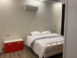 a bedroom with a bed with a red night stand at Near Mall Masr - Families only - 6 october - Luxury town house in 6th Of October