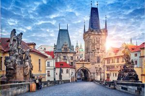 an old city with a gate and a building with towers at Andel apartment with terrace in Prague
