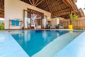 a swimming pool in a villa with a resort at Zanzibar Queen Hotel in Matemwe