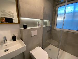 a bathroom with a shower and a toilet and a sink at ZEITraum1 Gummersbach in Gummersbach