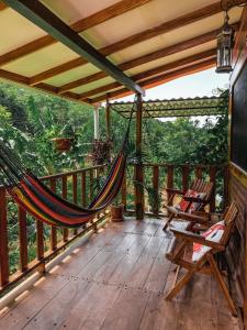 a hammock on the deck of a house at Casa Papaki in Mérida