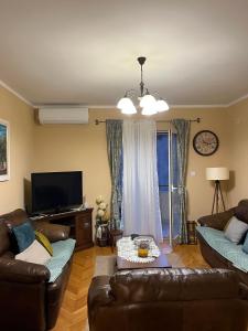 a living room with two couches and a tv at Apartman Nina in Kotor