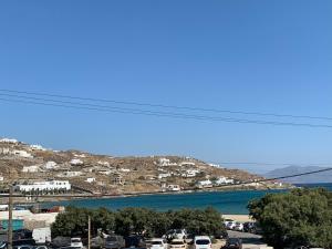 a parking lot with cars parked next to a body of water at Majestic Mykonos in Ornos