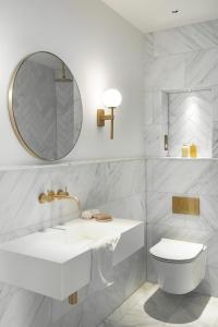 a white bathroom with a sink and a toilet at The Paragon, Bath in Bath