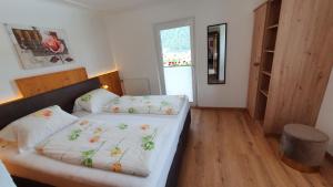 a bedroom with two beds and a window at Apart Edelhof in Mayrhofen