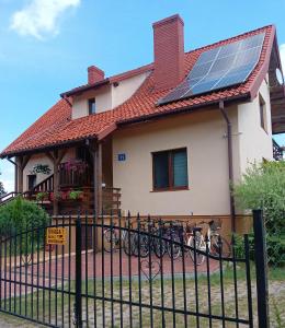 a house with solar panels on the roof at Wynajem pokoi WIKI in Mikołajki