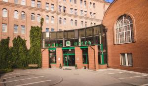 a large brick building with a sign on the front of it at TransHotel in Yekaterinburg