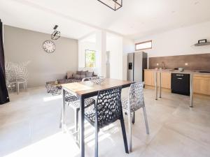 a kitchen and living room with a table and chairs at Fully renovated house only few minutes walk away from Ohama Beach in Vierville-sur-Mer